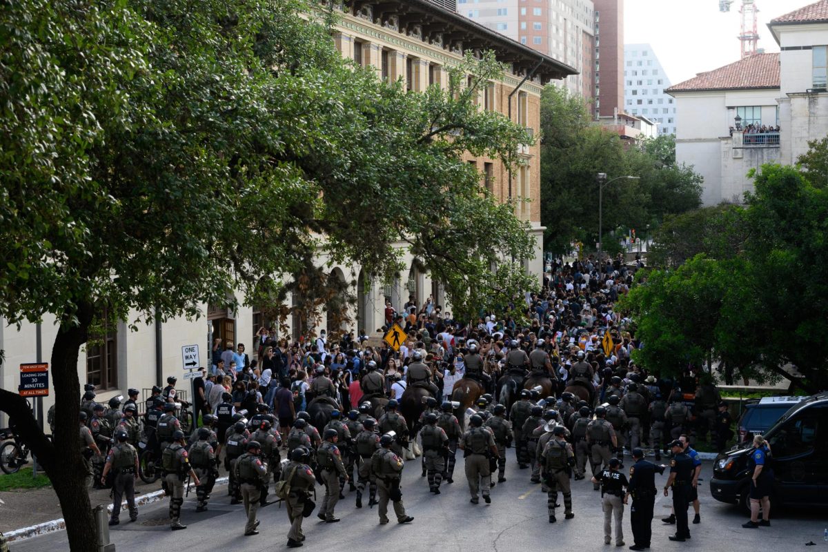 Law enforcement channels protesters past Sutton Hall on Wednesday during the pro-Palestine protest.